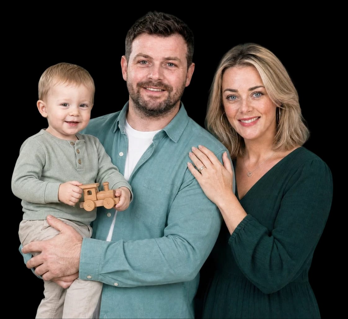Smiling family — parents holding their young son